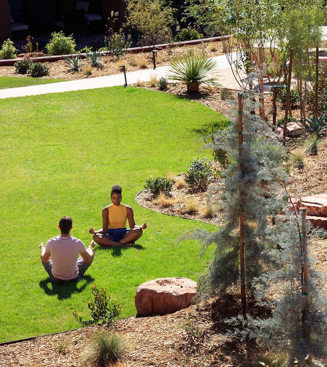 Two people at the Wilde Resort taking part in a yoga activity