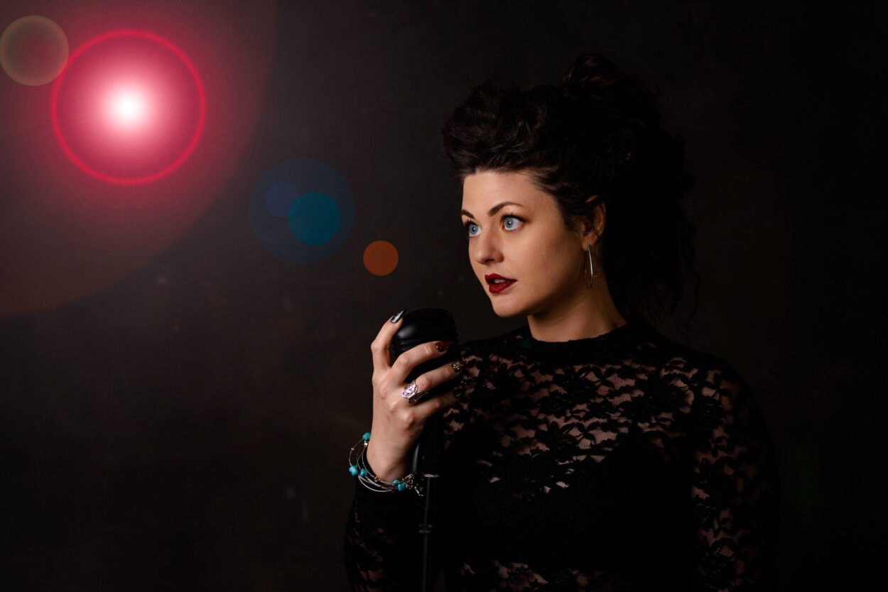 Woman singing into microphone